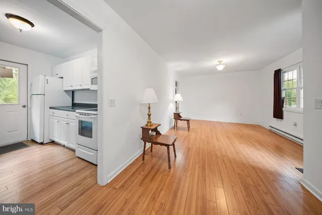 a large kitchen with granite countertop a sink and cabinets