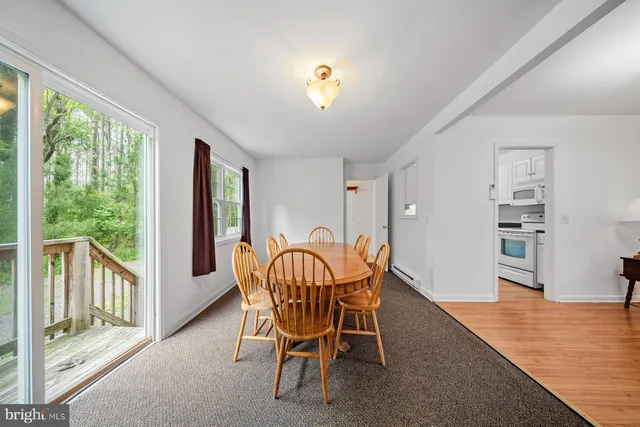 a dining room with furniture and window