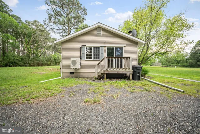 a view of a house with backyard and trees