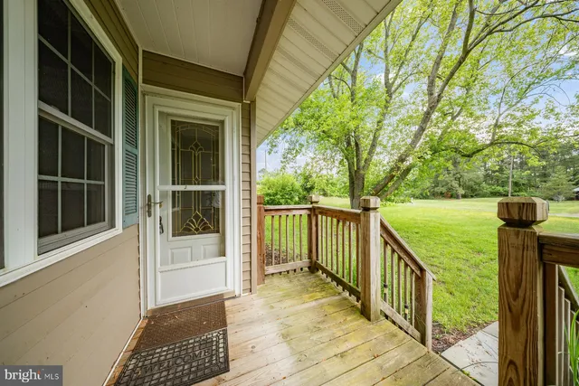 a view of a balcony with floor to ceiling window and wooden fence