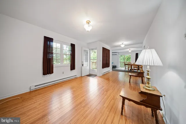 a kitchen with stainless steel appliances granite countertop a stove top oven a sink with dining table and chairs