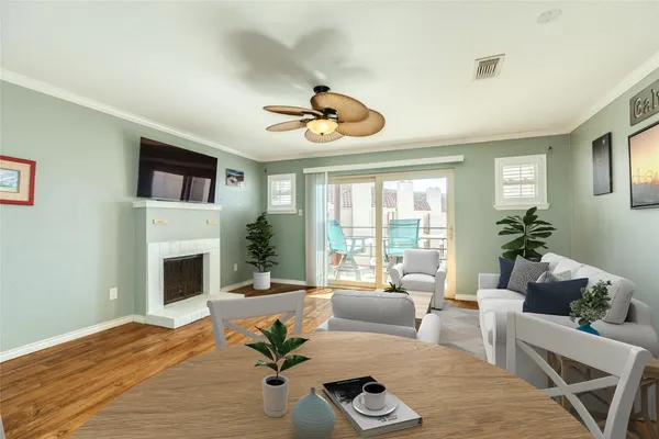 a living room with furniture fireplace and a large window