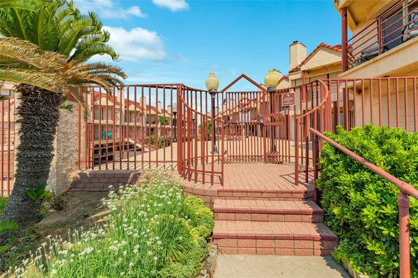 a view of a pathway of a house with a garden