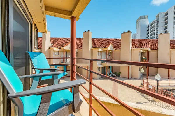 a view of a balcony with chairs