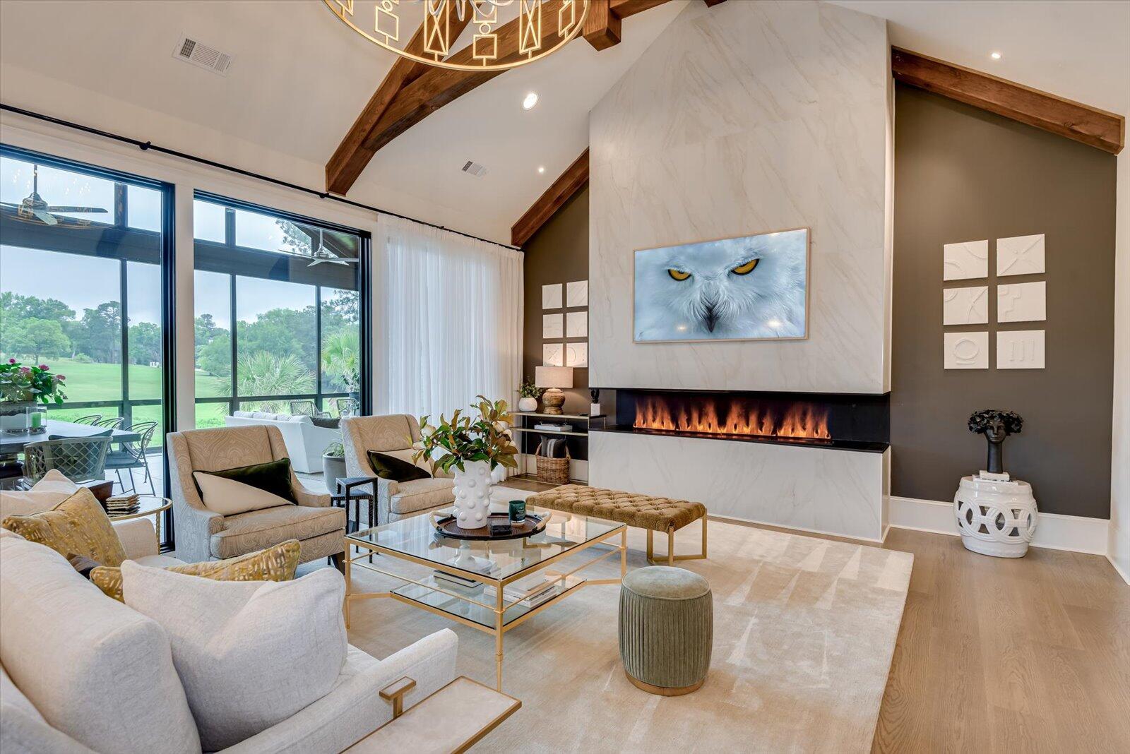 2025 Grace Avenue Evans, GA 30809 - Photo 13 of 67 Tiled fireplace feature wall with Dimplex, Opti-mist; water mist fireplace. Floor to ceiling windows.