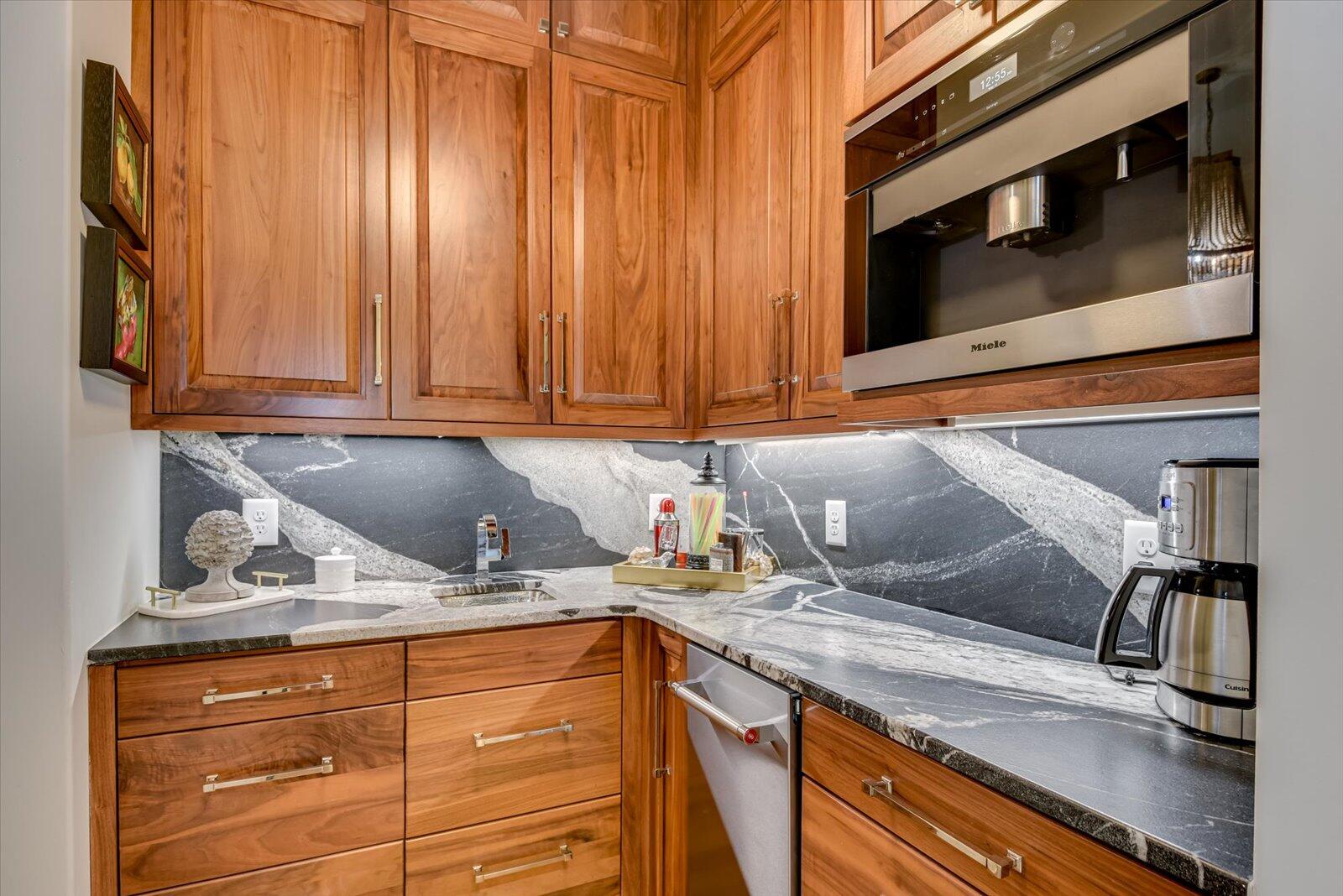 2025 Grace Avenue Evans, GA 30809 - Photo 20 of 67 Butler Pantry. Granite Countertops. Dark walnut cabinetry with nickel hardware. Miele Built-in coffee maker. Kitchen Aid built-in ice machine.