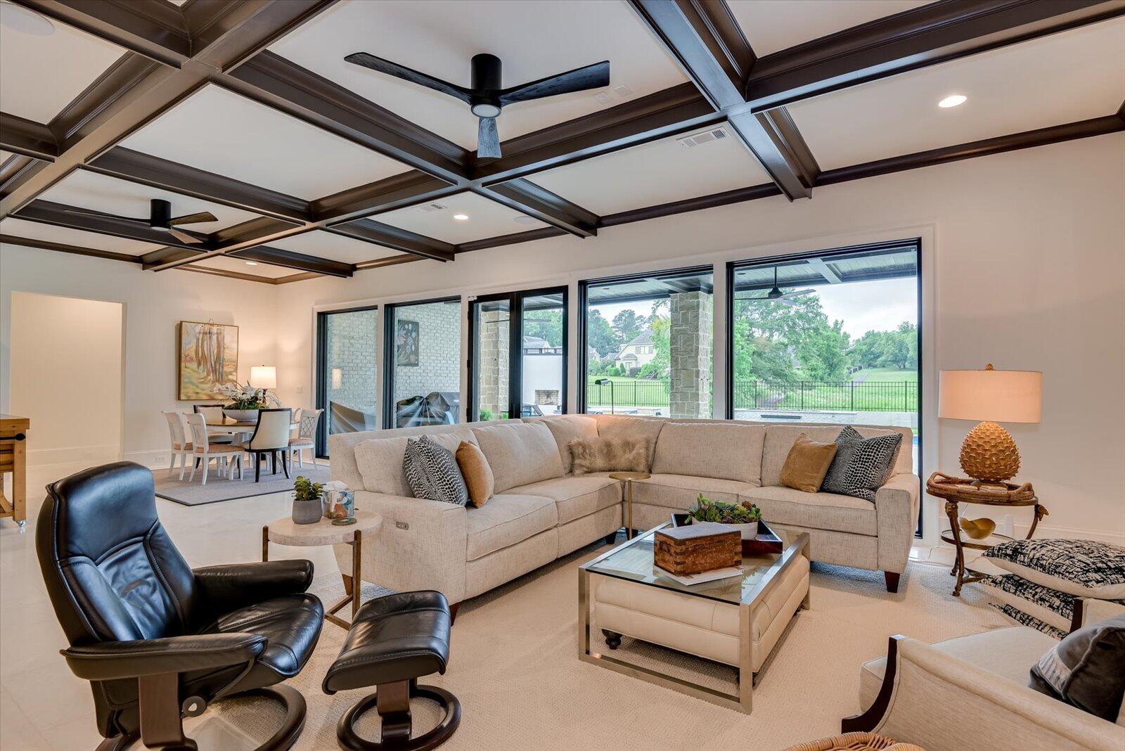 2025 Grace Avenue Evans, GA 30809 - Photo 34 of 67 Living/Entertainment Room- Turkish stone flooring throughout the lower level. Floor to ceiling windows. Upgraded ceiling fans. Coffered ceiling.