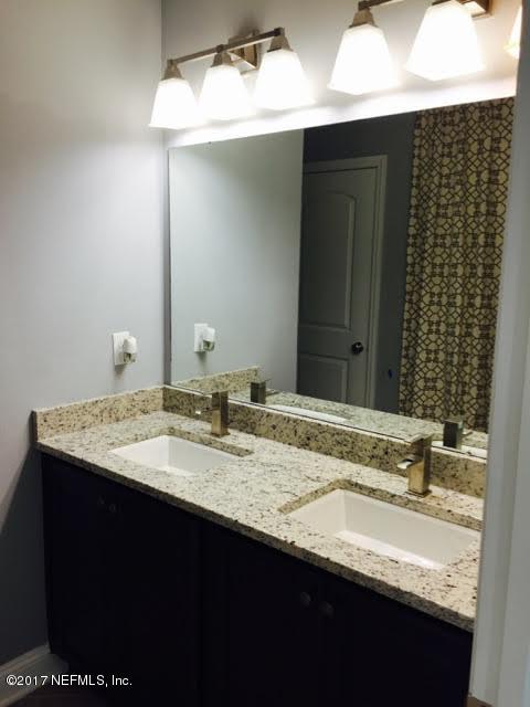 63 Redland Way Jacksonville, FL 32218 - Photo 12 of 14 a bathroom with a granite countertop sink and a mirror