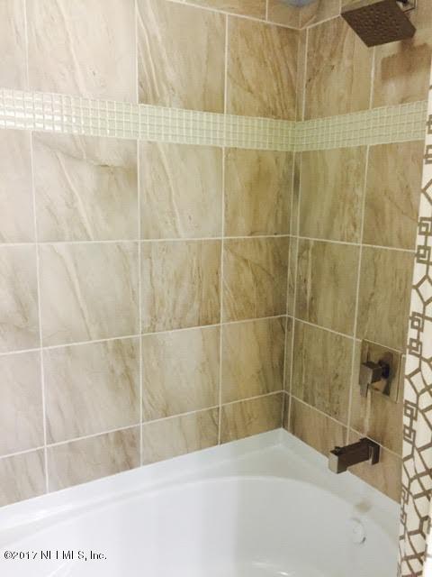 63 Redland Way Jacksonville, FL 32218 - Photo 13 of 14 a bathroom with a bathtub