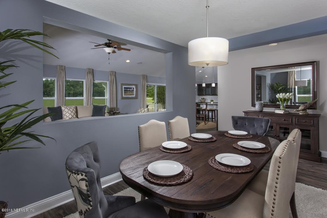 63 Redland Way Jacksonville, FL 32218 - Photo 9 of 14 a dining room with furniture a chandelier and window