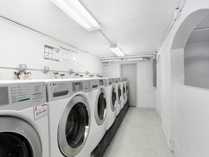 a view of washer and dryer with kitchen in the background