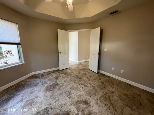 a view of a room with a ceiling fan