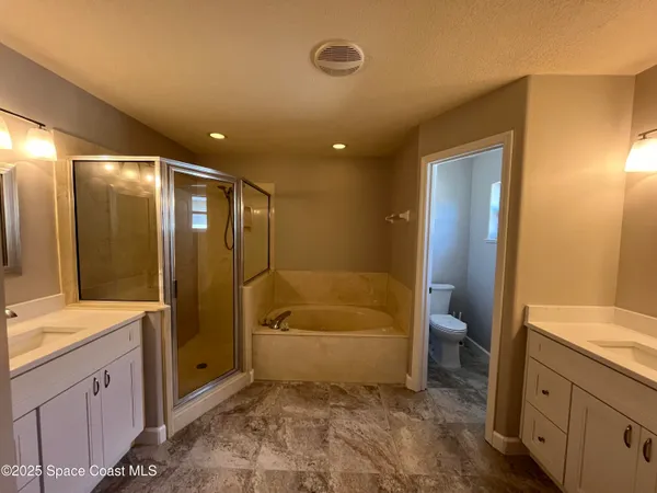 a bathroom with a tub a sink and mirror