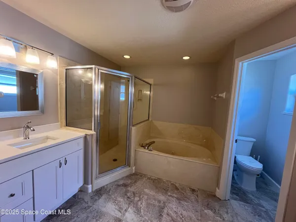 an empty room with a fan & a ceiling fan