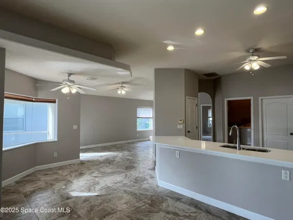 a kitchen with a sink stainless steel appliances and white cabinets