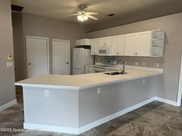 a white refrigerator freezer sitting in a kitchen