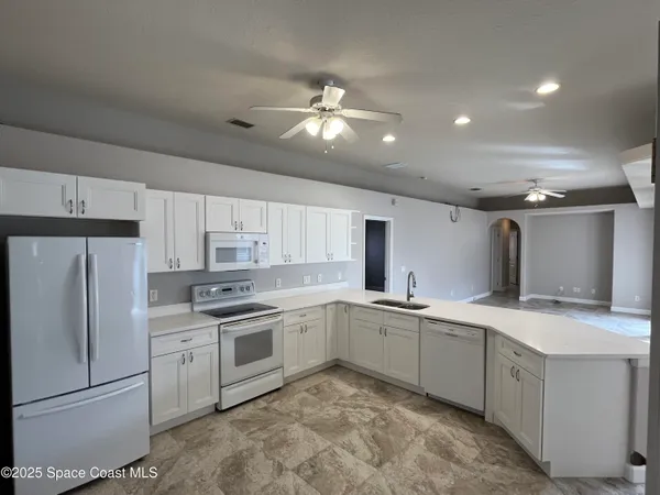 a view of an empty room with a fireplace and a window