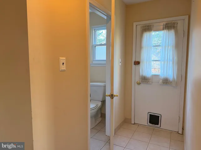 a view of a hallway with a room and a bathroom