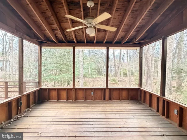 a view of a room with wooden floor and a large window
