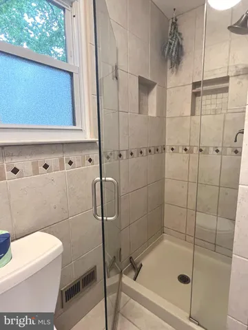 a bathroom with a shower and toilet