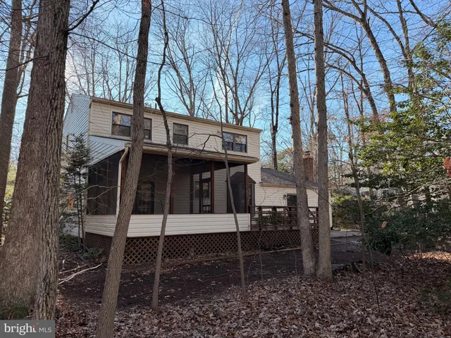 a view of a chairs and table in the backyard
