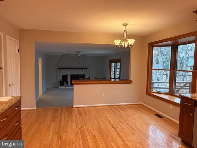 a view of a room with wooden floor and a window