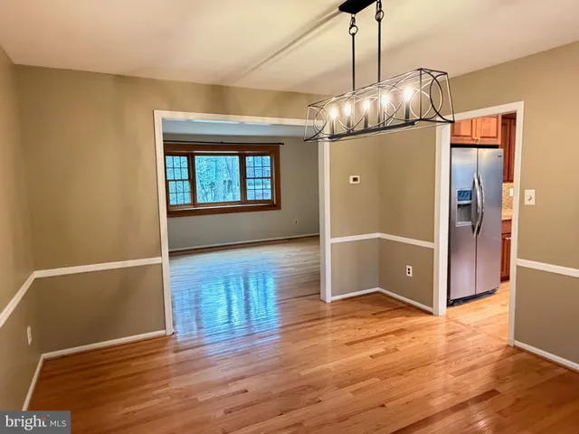 a view of kitchen and dining room with wooden floor