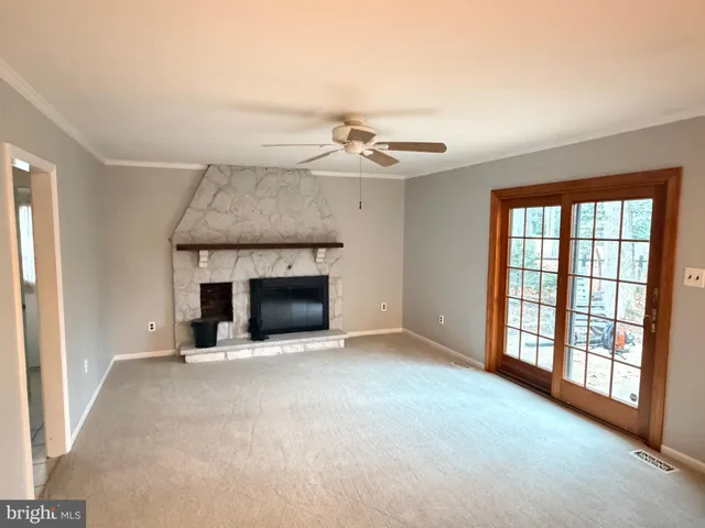 a view of an empty room with a fireplace