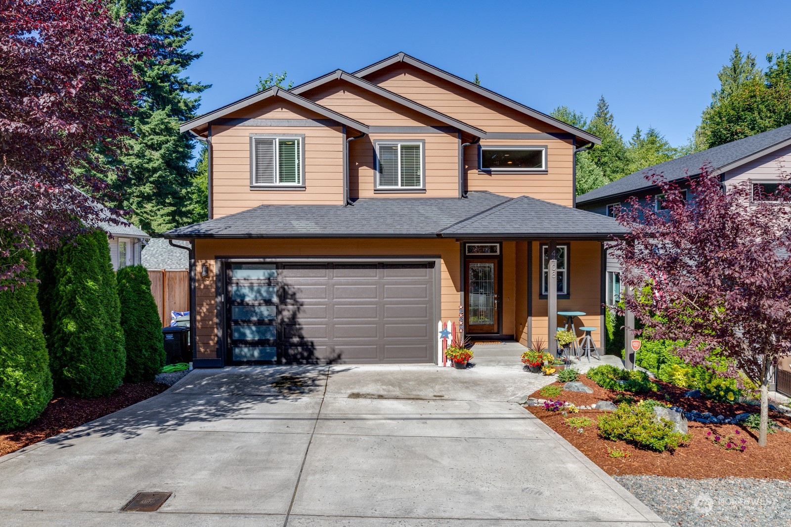 a front view of a house with a yard and garage