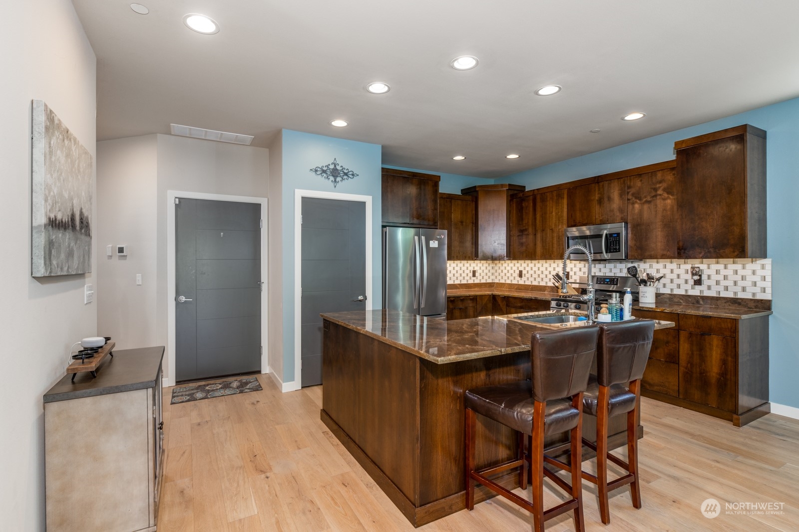 4408 Forest Drive Everett, WA 98203 - Photo 11 of 32 a kitchen with stainless steel appliances kitchen island granite countertop a refrigerator and a stove top oven