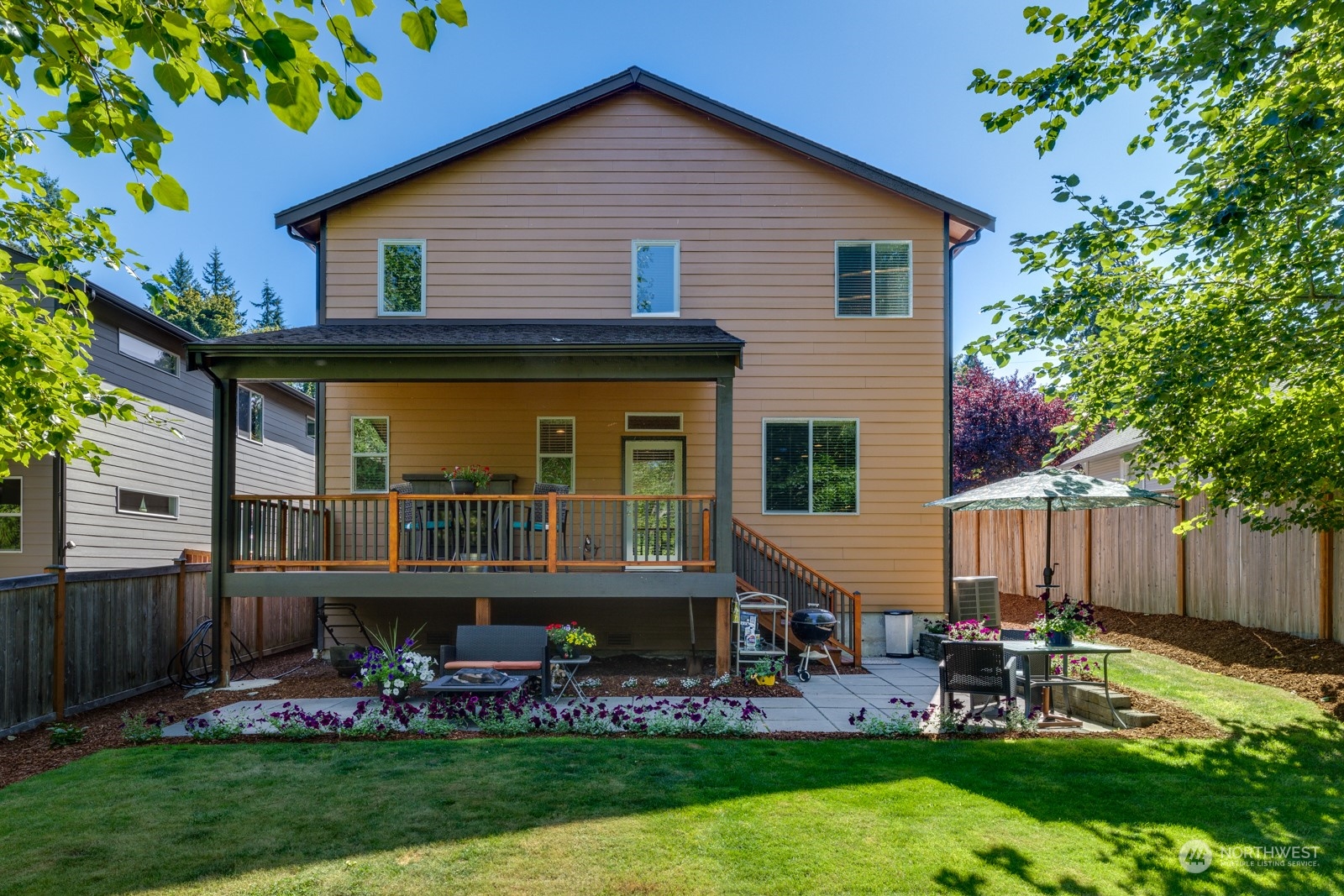 4408 Forest Drive Everett, WA 98203 - Photo 28 of 32 a view of a house with a yard patio and a garden
