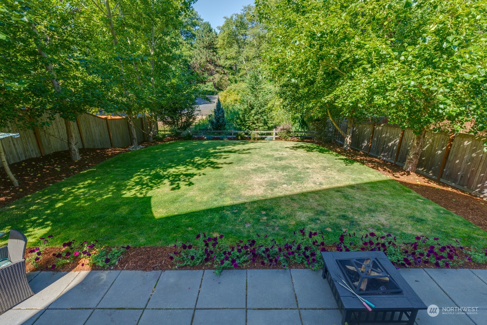 4408 Forest Drive Everett, WA 98203 - Photo 30 of 32 a view of a backyard with potted plants and large trees