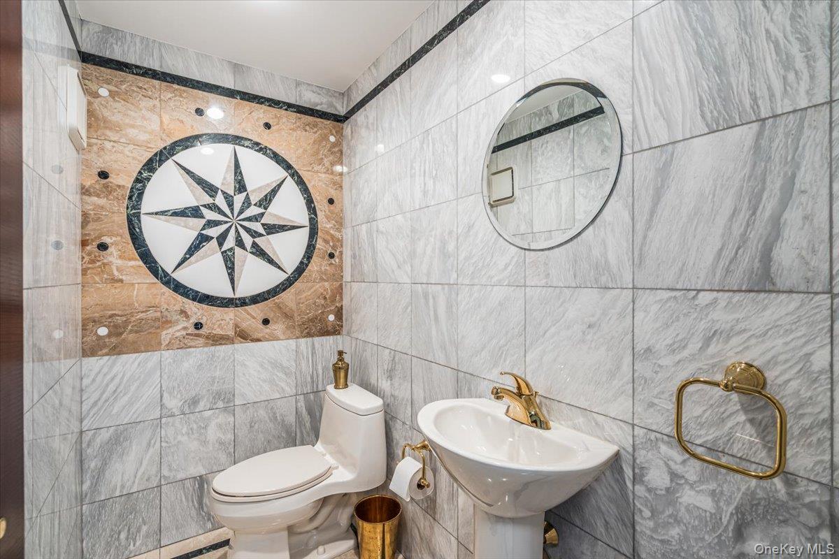 154-43 Riverside Drive Queens, NY 11357 - Photo 23 of 41 a bathroom with a sink a mirror and a toilet