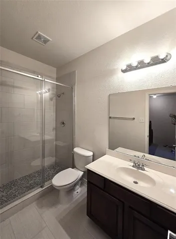 a bathroom with a double vanity sink toilet and shower