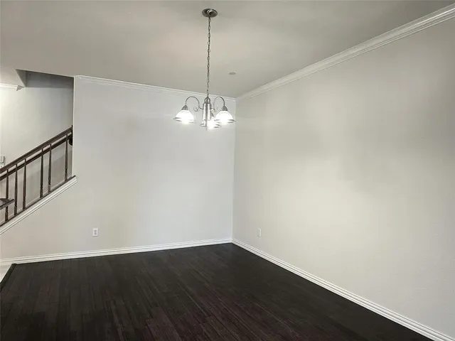 a view of a room with wooden floor and chandelier