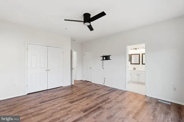 a view of empty room with wooden floor