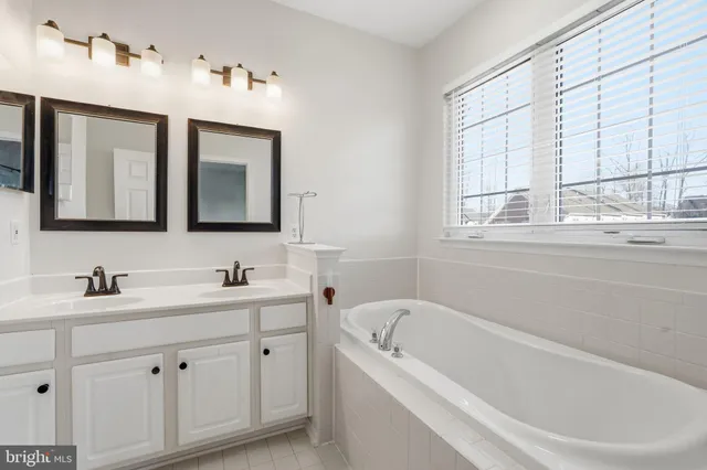 a white bath tub sitting next to a white sink