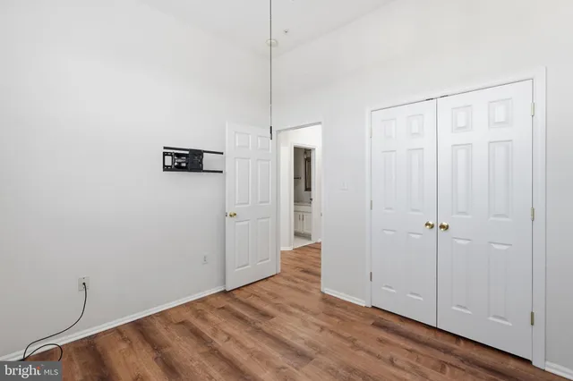 a view of a room with wooden floor