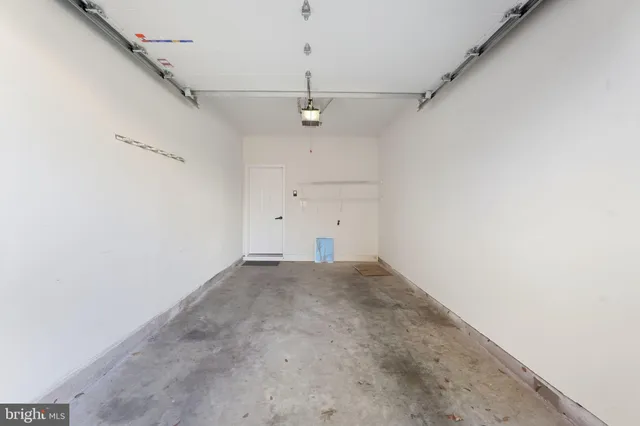 an empty room with a ceiling fan and window