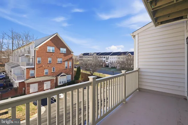 a view of a brick house with a small yard