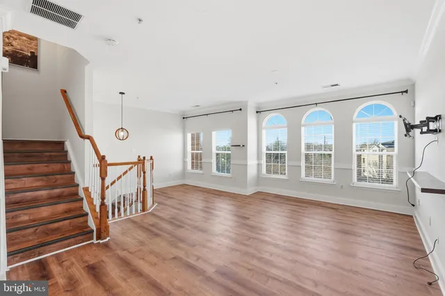 a view of an room with wooden floor and windows