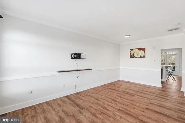 a view of a room with wooden floor