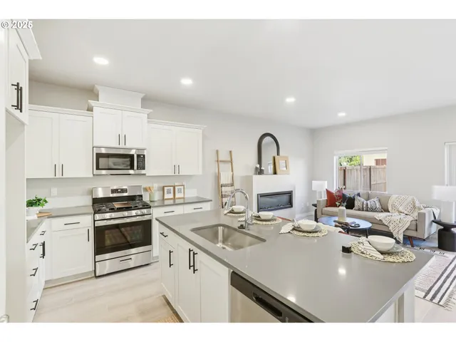 a kitchen with kitchen island a sink appliances and cabinets