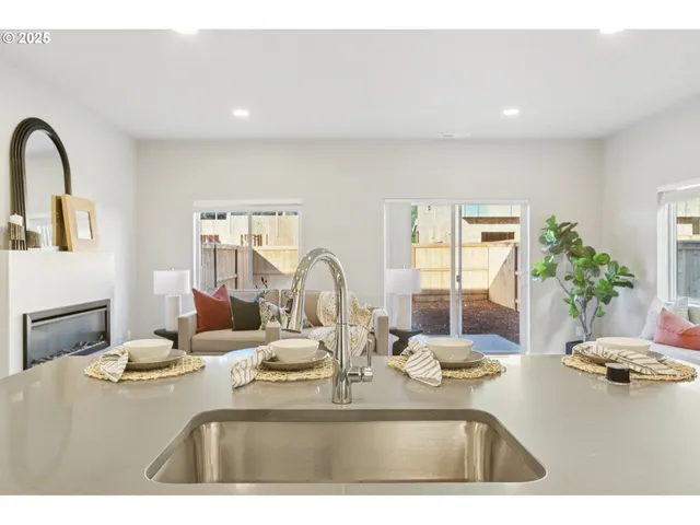 a kitchen with a faucet a sink and living room