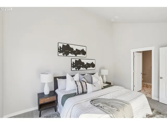 a bedroom with a bed and a lamp