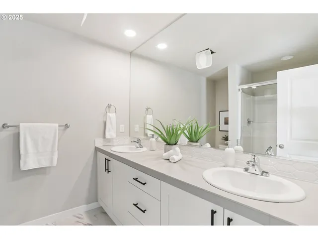a bathroom with a sink double vanity and a mirror