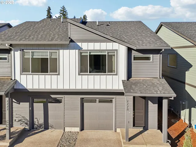 a view of a house with wooden fence