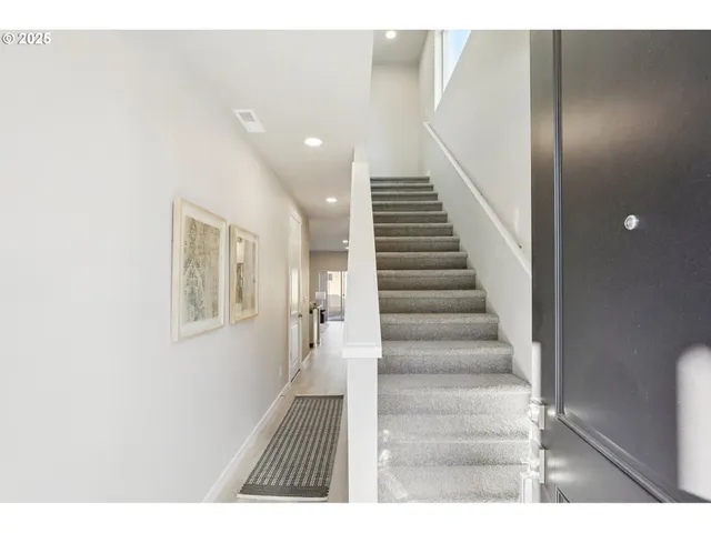 a view of an entryway with wooden floor