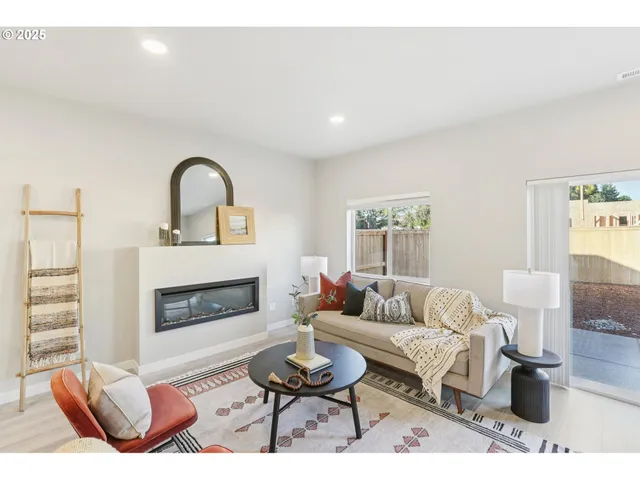 a living room with furniture a fireplace and a table