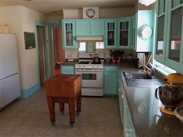 149 Market Street Amesbury, MA 01913 - Photo 3 of 23 a kitchen with a stove a table and chairs